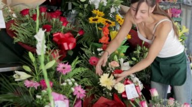 woman working and preparing flower arrangements in her shop