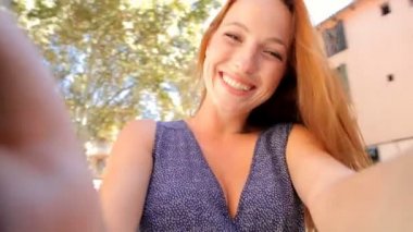 woman taking selfies videos of herself on camera