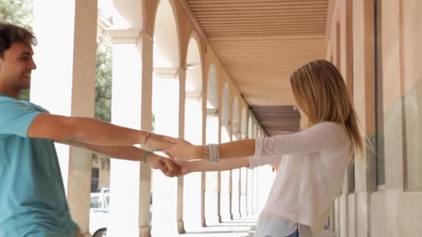 Pareja dando la vuelta en un sendero de arco — Vídeos de Stock