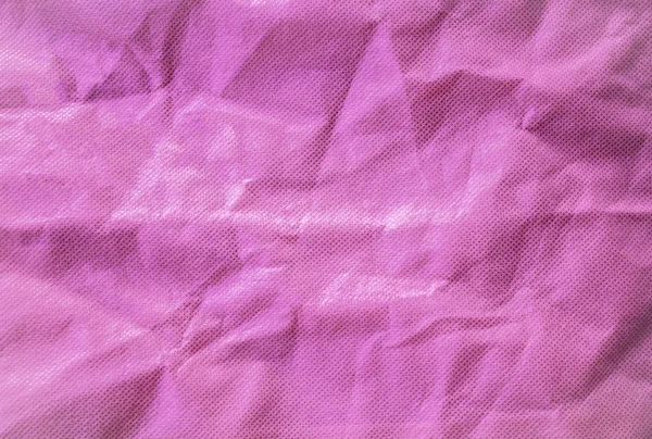 Closeup rosa vazio enrugamento tecido rugas fundo — Fotografia de Stock
