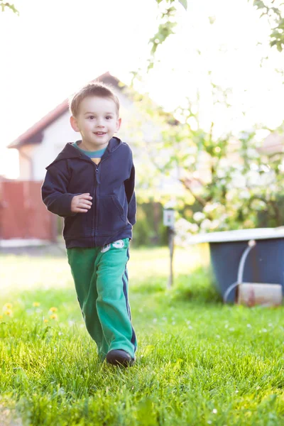 Running little boy in the garden — Stock Photo, Image