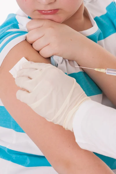 Doctor giving a child injection in arm on isolated image. — Stock Photo, Image