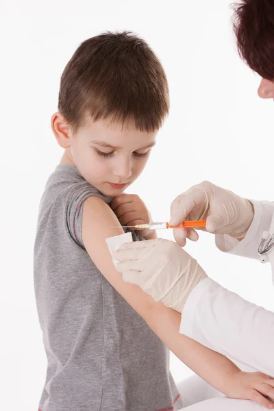 Doctor giving a child injection in arm on isolated image. — Stock Photo, Image