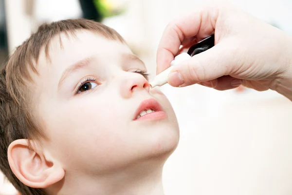 Ill boy with flu and drops in the nose — Stock Photo, Image
