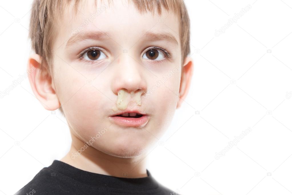 Ill boy with flu and green rhinitis at nose - isolated image