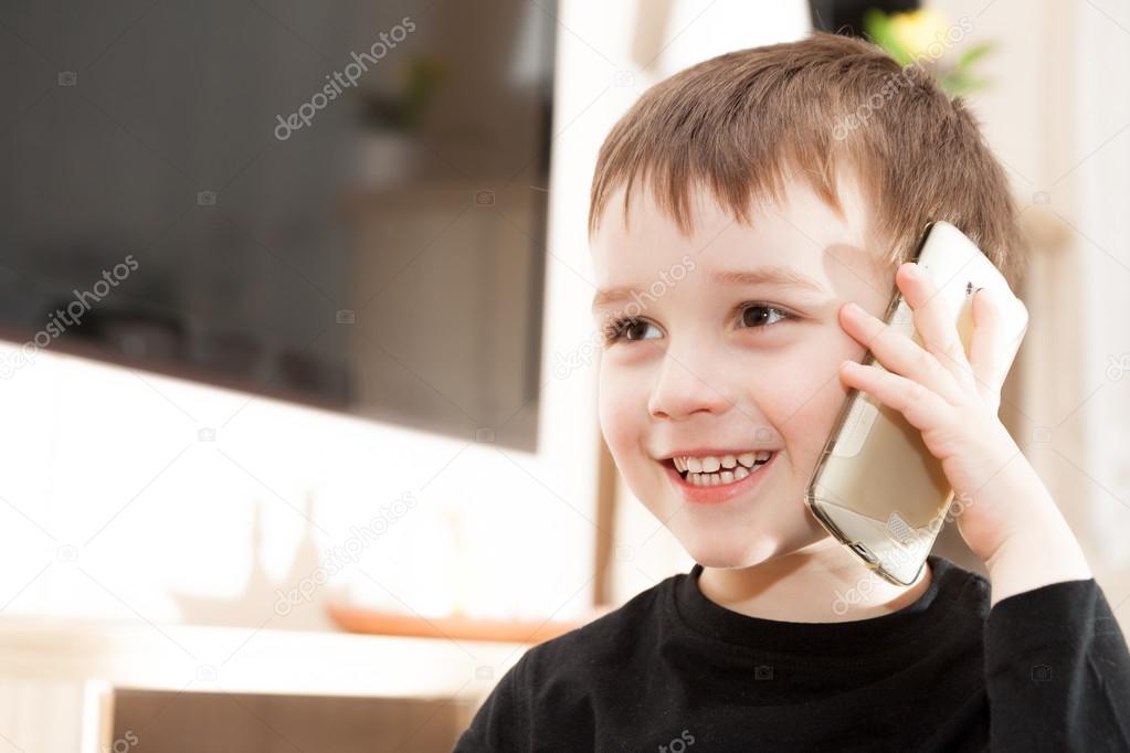 Cute little baby boy is talking on cell phone