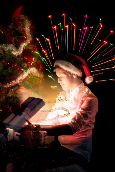 Boy in a cap santa claus with magic box — Stock Photo, Image
