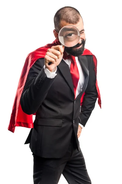 Super hero businessman with magnifying glass — Stock Photo, Image