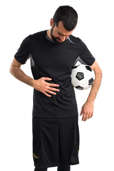 Футболист с болью в животе — стоковое фото