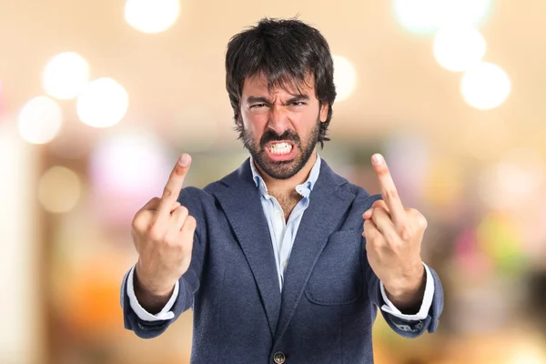 Hombre de negocios haciendo gesto cuerno sobre fondo blanco — Foto de Stock