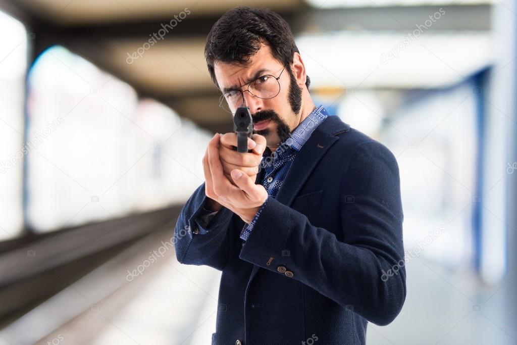 Vintage young man shooting with a pistol 