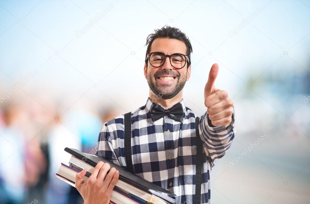 Happy posh boy holding books