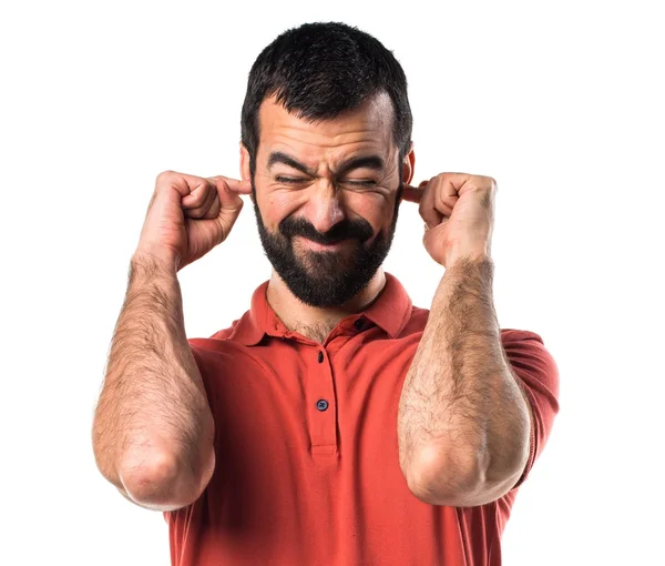 Stilig man som täcker öronen — Stockfoto