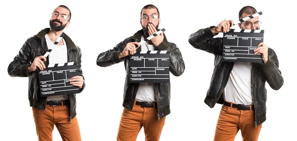 Hombre con una chaqueta de cuero sosteniendo un clapperboard —  Fotos de Stock