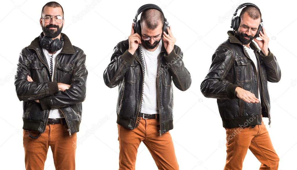 Man wearing a leather jacket listening music