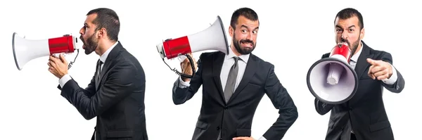 Businessman shouting by megaphone — Stock Photo, Image