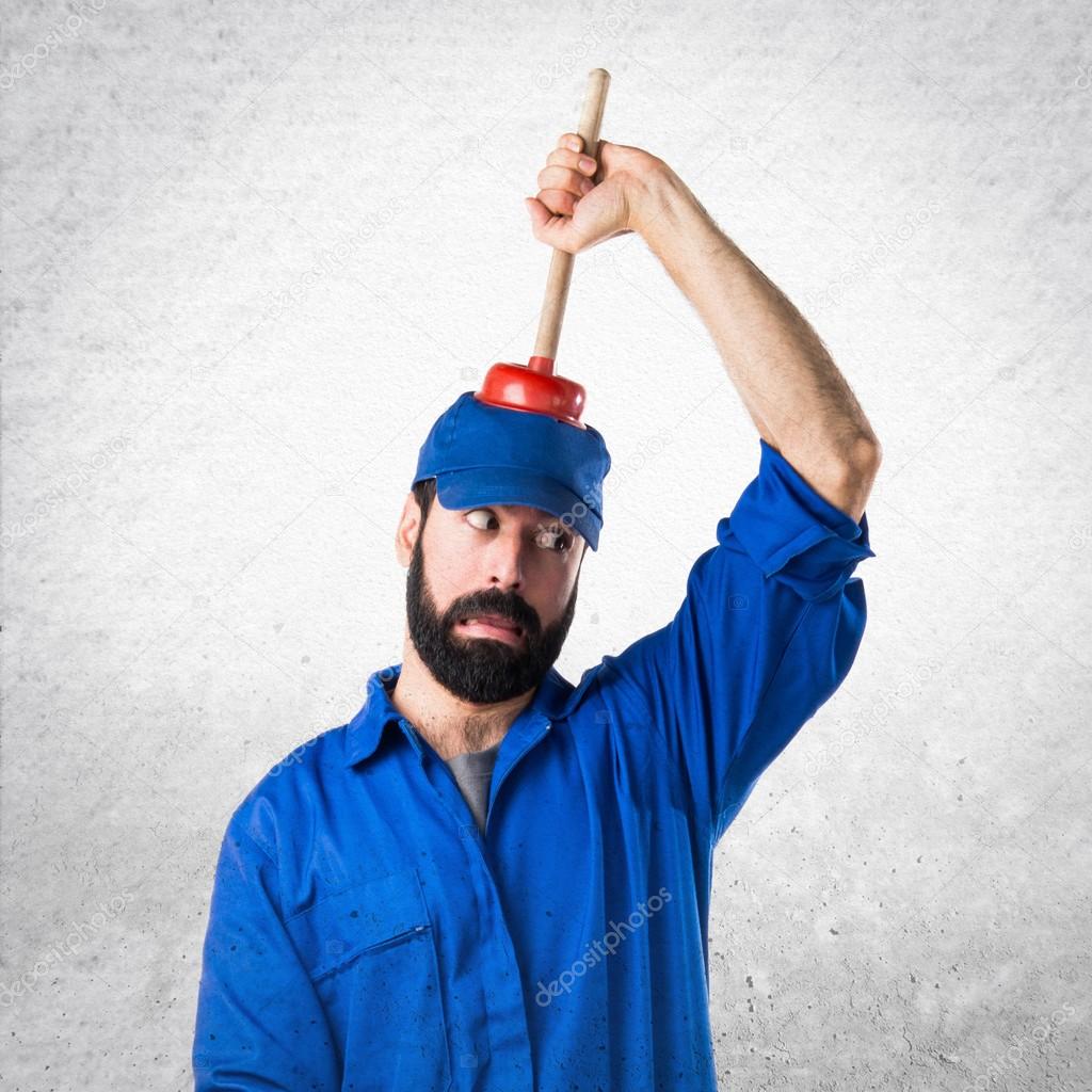 Crazy plumber holding a plunger