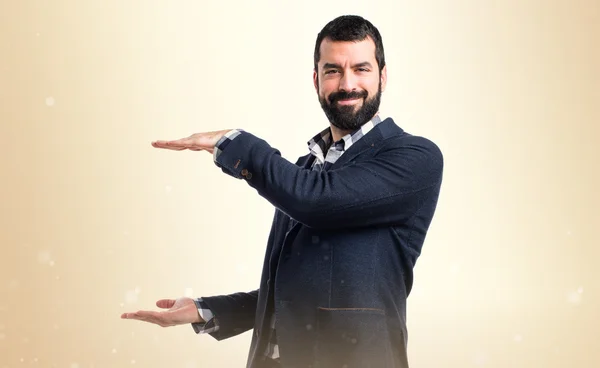 Handsome man holding something — Stock Photo, Image