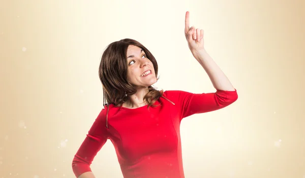 Brunette woman pointing up — Stock Photo, Image