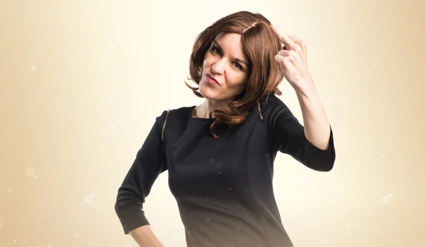 Brunette woman making horn gesture — Stock Photo, Image