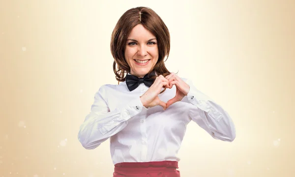 Waitress making a heart with her hands — Stock Photo, Image