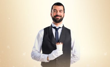 Bir fincan kahve tutan lüks garson