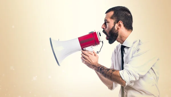 Businessman shouting by megaphone — Stock Photo, Image