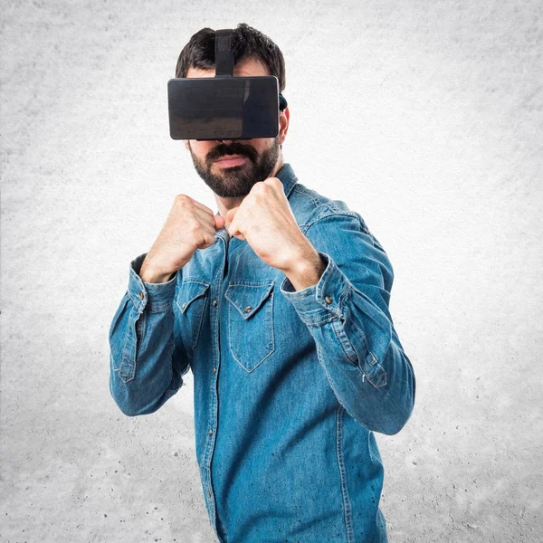 Man using VR glasses giving a punch — Stock Photo, Image