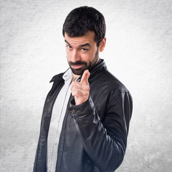 Man with leather jacket pointing to the front