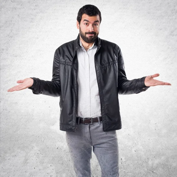 Man with leather jacket making unimportant gesture — Stock Photo, Image