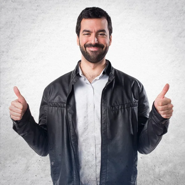 Man with leather jacket with thumb up — Stock Photo, Image