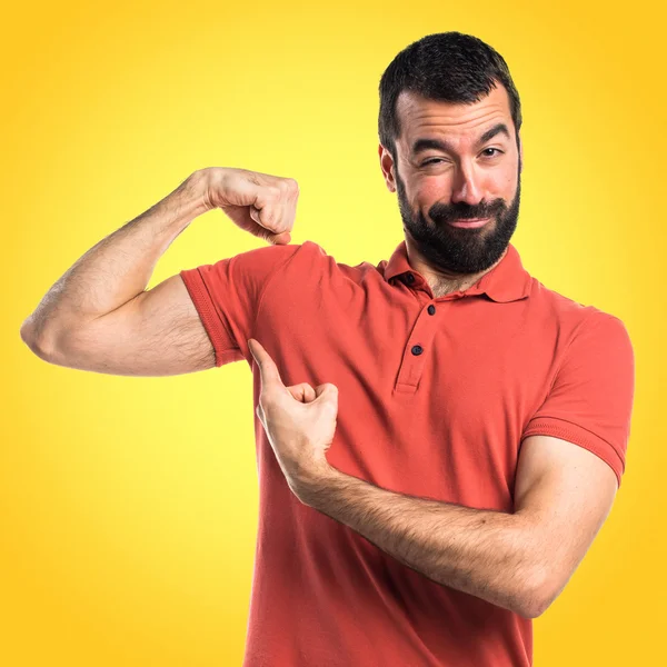 Handsome man making strong gesture — Stock Photo, Image