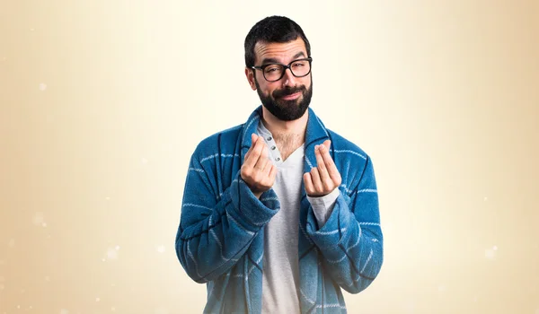 Man in dressing gown doing a money gesture — Stock Photo, Image