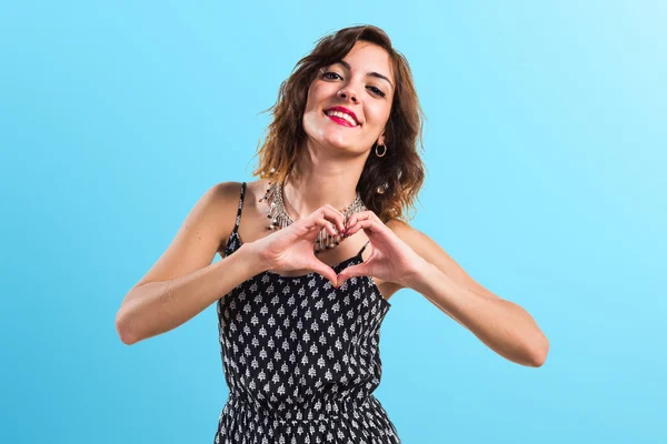 Pretty girl making a heart with her hands — Stock Photo, Image