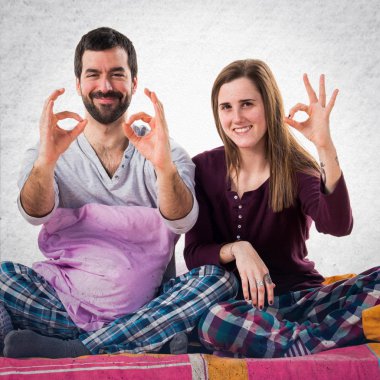 Ok işareti yapmak bir yatakta üç arkadaş