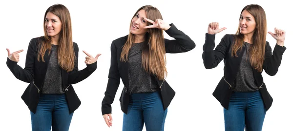 Girl doing victory gesture with her hair on her face — Stock Photo, Image