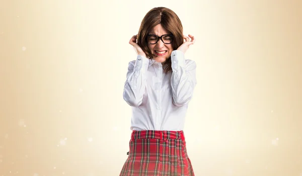 Teen student girl covering her ears — Stock Photo, Image