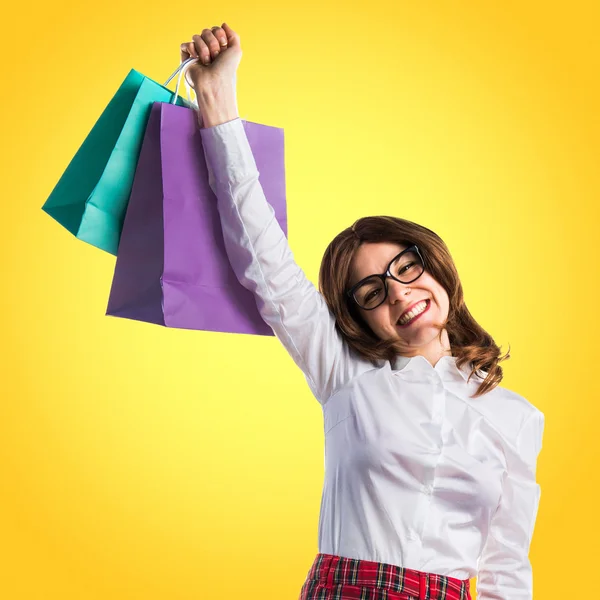 Frau mit vielen Einkaufstüten — Stockfoto