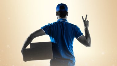 Delivery man doing victory gesture