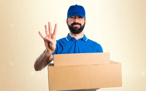 Delivery man counting four — Stock Photo, Image