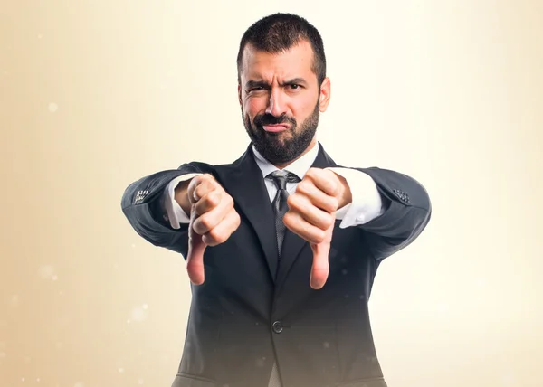 Businessman doing bad signal — Stock Photo, Image