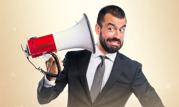 Businessman shouting by megaphone — Stock Photo, Image