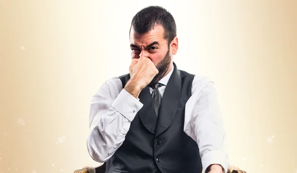 Businessman making smelling bad gesture — Stock Photo, Image