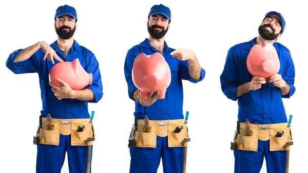 Plumber holding a piggybank — Stock Photo, Image