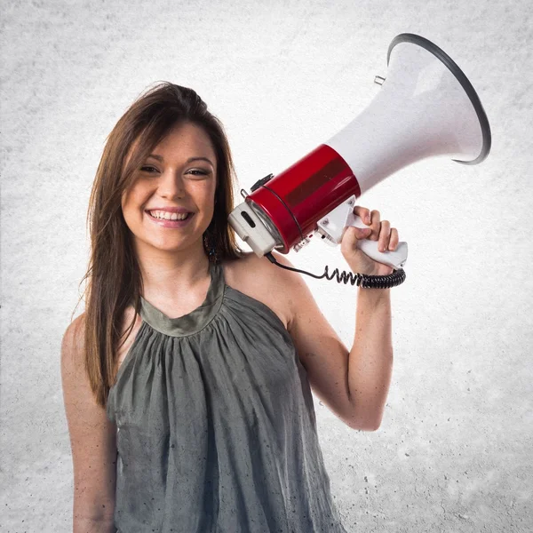 Young girl shouting by megaphone — Stock Photo, Image