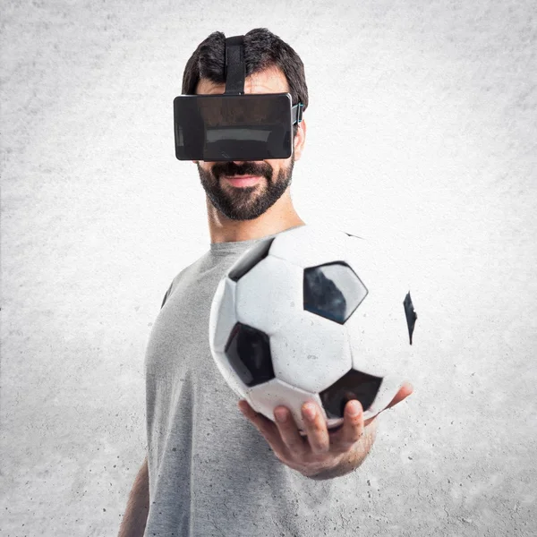 Man playing soccer using VR glasses — Stock Photo, Image