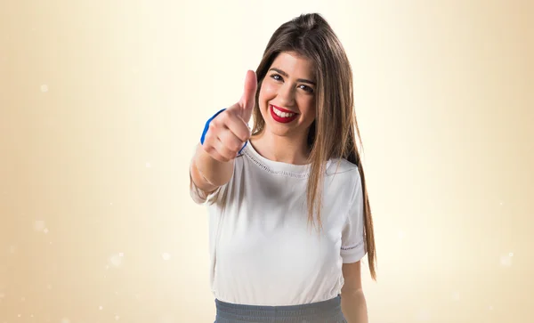 Young girl with thumb up — Stock Photo, Image