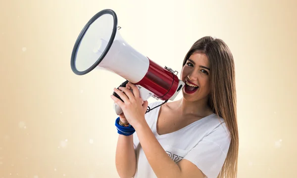 Young girl shouting by megaphone — Stock Photo, Image