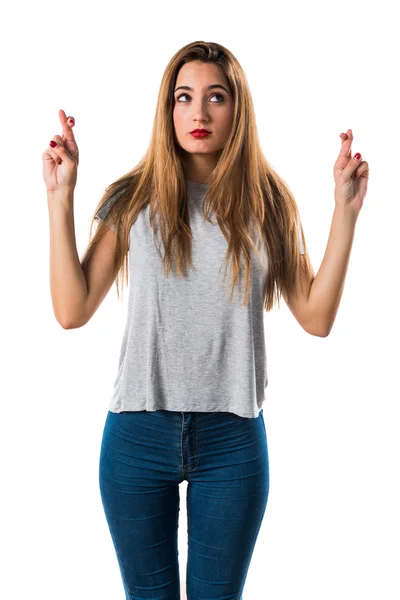 Jong meisje met haar vingers oversteken — Stockfoto