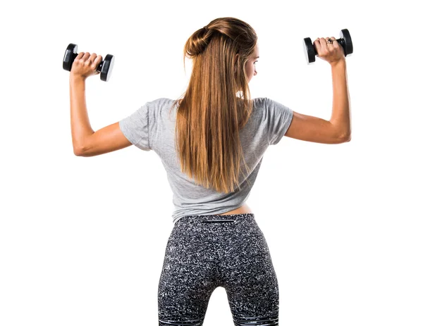 Mujer joven haciendo levantamiento de pesas — Foto de Stock